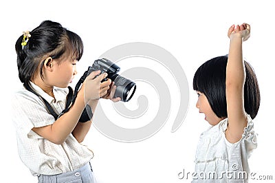 Asian little siblings child taking photograph of each other with Stock Photo