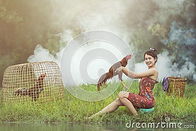 Asian local woman with cock fighting Stock Photo