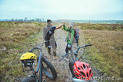 Asian lover women and men Travel photograph nature. Travel relax ride a bike Wilderness in the wild.Stand on the line. In the Stock Photo