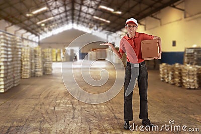 Asian male courier delivery holding package with open arm Stock Photo