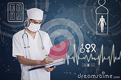 Asian male doctor making notes Stock Photo