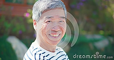 Asian male elder smiile at you Stock Photo