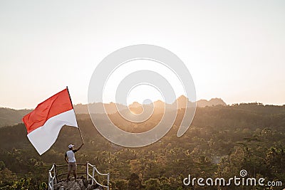 Asian male with indonesian flag celebrating independence day Stock Photo