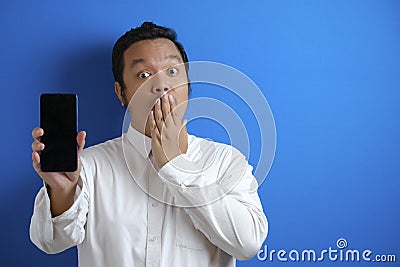 Asian male office worker looks confident while accessing his smart phone Stock Photo
