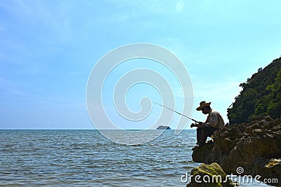 Asian male photographer is taking a with patience Stock Photo