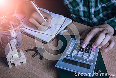 Asian man accountant or banker calculate finances / savings money or economy for rent home Stock Photo