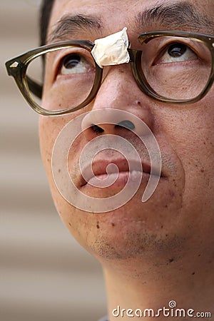 Asian Man in Broken Glasses Stock Photo
