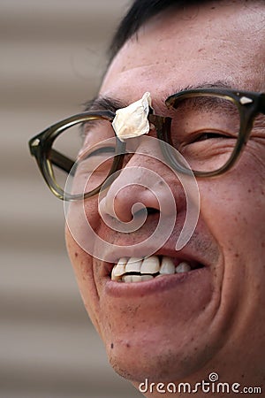 Asian Man in Broken Glasses Stock Photo