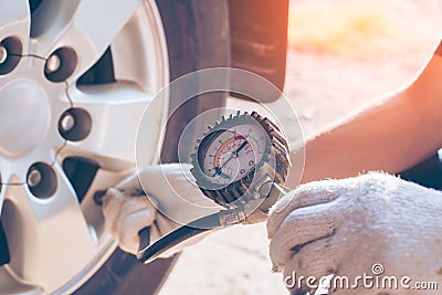 Asian man car inspection Measure quantity Inflated Rubber tires car Stock Photo