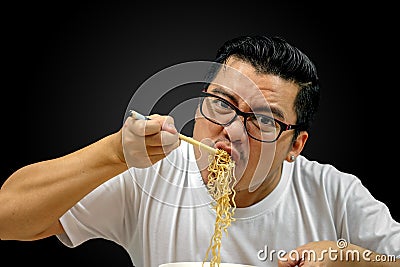 Asian man eating Instant noodles Stock Photo