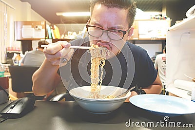 Asian man eating Instant noodles very hot and spicy Stock Photo