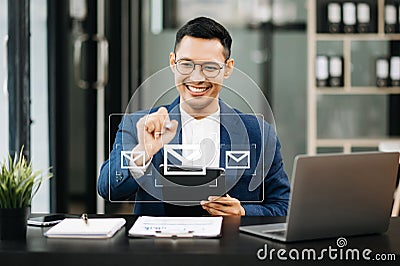 Man hands using Laptop, tablet typing on keyboard and surfing the internet with email icon, email marketing concept, send e-mail Stock Photo