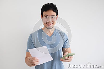 Man is happy by the smartphone and the bill on an isolated background. Stock Photo