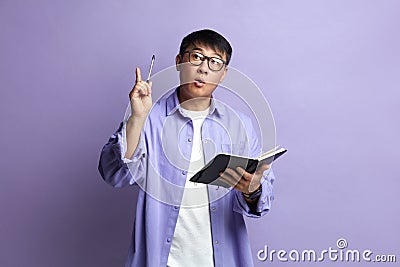 Asian Man Having Idea. Portrait of Inspired Handsome Man Pointing Pencil Up Stock Photo