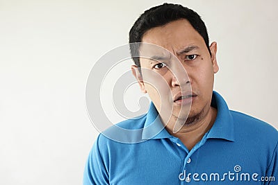 Asian Man Having Skeptical and Dissatisfied or Distrust Expression Stock Photo