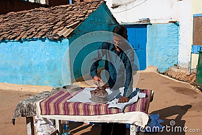 Asian man irons clothes by the coal iron outdoor Editorial Stock Photo