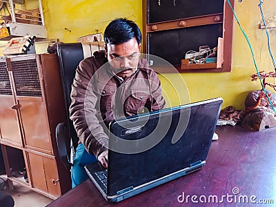 asian man learning about laptop computer system at shop counter in india January 2020 Editorial Stock Photo