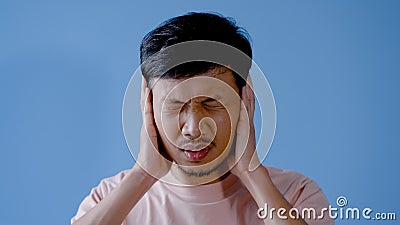 Asian man mustache,Half of the young man raised his hands to cover his ears , in frustration , Stock Photo