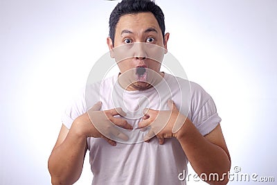 Asian Man Pointing Himself with Unhappy Expression as if he confused to be accused Stock Photo