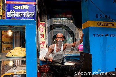 Asian man prepares simple street food outdoor Editorial Stock Photo