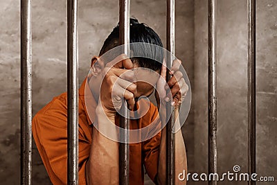 Asian man in prison alone Stock Photo