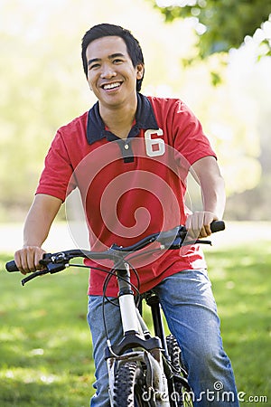 Asian man riding bike in park Stock Photo