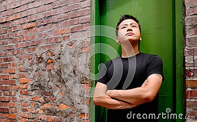 Asian man stand against a old door and lonely Stock Photo