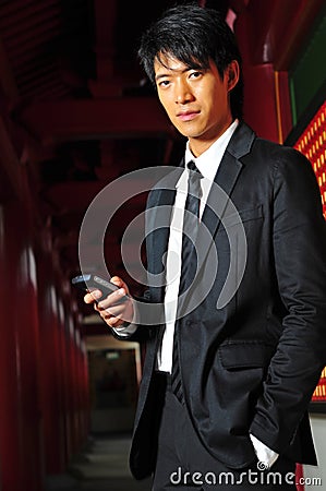 Asian Man In Suit with Phone Stock Photo