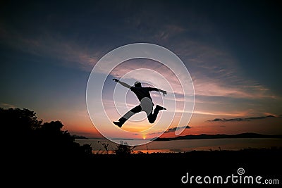 Asian man traveler is jumping on top of a rainforest mountain in Stock Photo