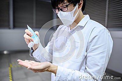 Asian man using hand sanitizer gel washing hand Stock Photo