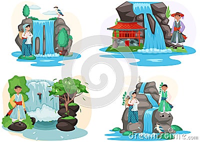 Asian man and woman dressed in national clothes standing next to waterfall in mountaine landscape Stock Photo