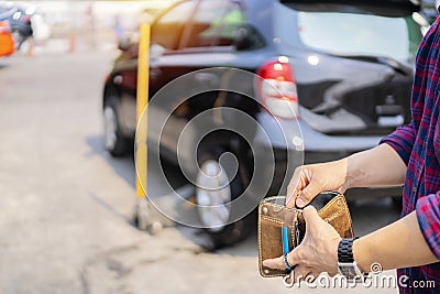 Asian men are paying for car repairs Stock Photo