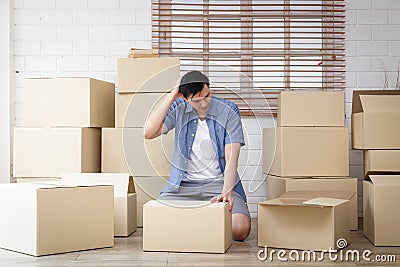 Asian men prepare to move to new homes Put your belongings in large cardboard boxes to transport. Stock Photo