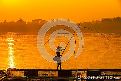 Asian men are using nets to fish in the Mekong River. Fishermen raising nile tilapia, floating cages on the Mekong River. Nongkhai Stock Photo