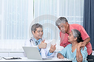 Asian middle-aged man doctor is introducing the product Supplements to nourish the body and treat disease Stock Photo
