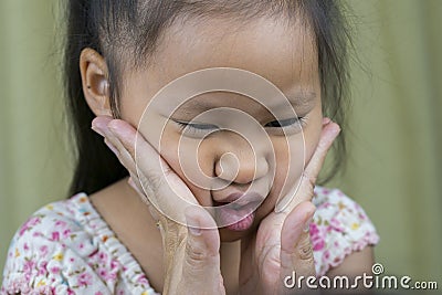 Asian mother and child girl playing pinch cheeks, touch nose funny face Stock Photo