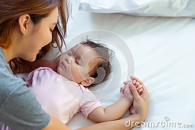 Asian mother lull kid, adopt little girl to be her protege or daughter Single mother admire with love, fondness of caucasian Stock Photo