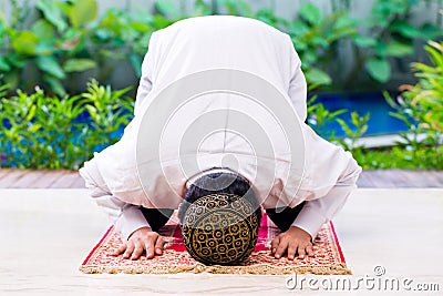 Asian Muslim man praying on carpet Stock Photo