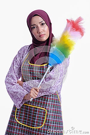 Asian Muslim wearing apron and hold a cleaner Stock Photo