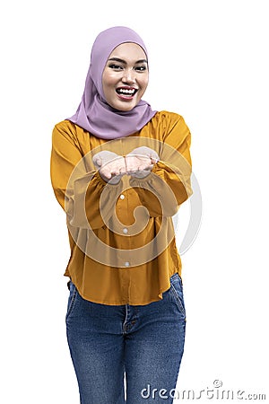 Asian Muslim woman in a headscarf with an open palm showing something Stock Photo