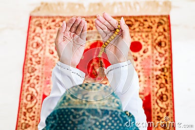 Asian Muslim woman praying with beads chain Stock Photo