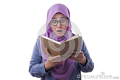 Muslim Woman Shocked when Reading a Book Stock Photo