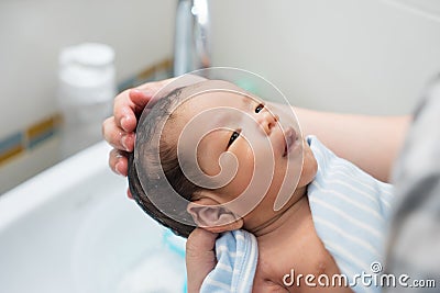 Asian newborn baby having a bath Stock Photo