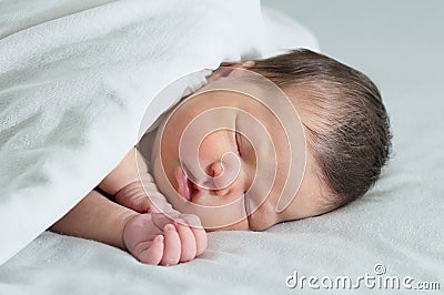 Asian newborn sleeping under white blanket, asian baby portrait Stock Photo