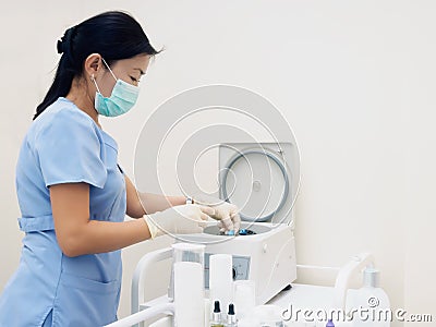 Asian nurse prepare blood separator centrifugal machine to separation Stock Photo