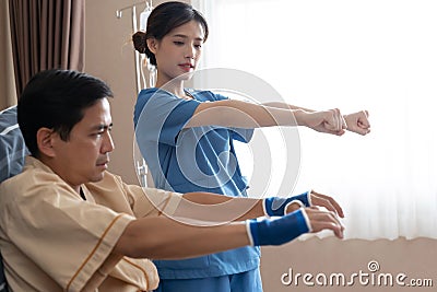 Asian nurse therapists stretching arm muscles treatment of physiological. Stock Photo