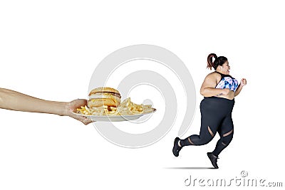 Asian obese woman runs from fast food offered Stock Photo