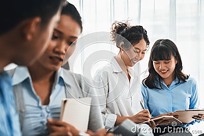 Asian office worker with smile working together in office. Meticulous Stock Photo