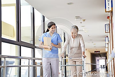 Asian old woman walking with a walker in rehab center Stock Photo