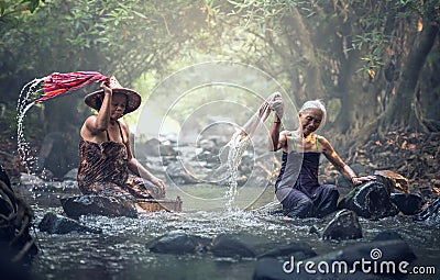 Asian old women washing clothes Stock Photo